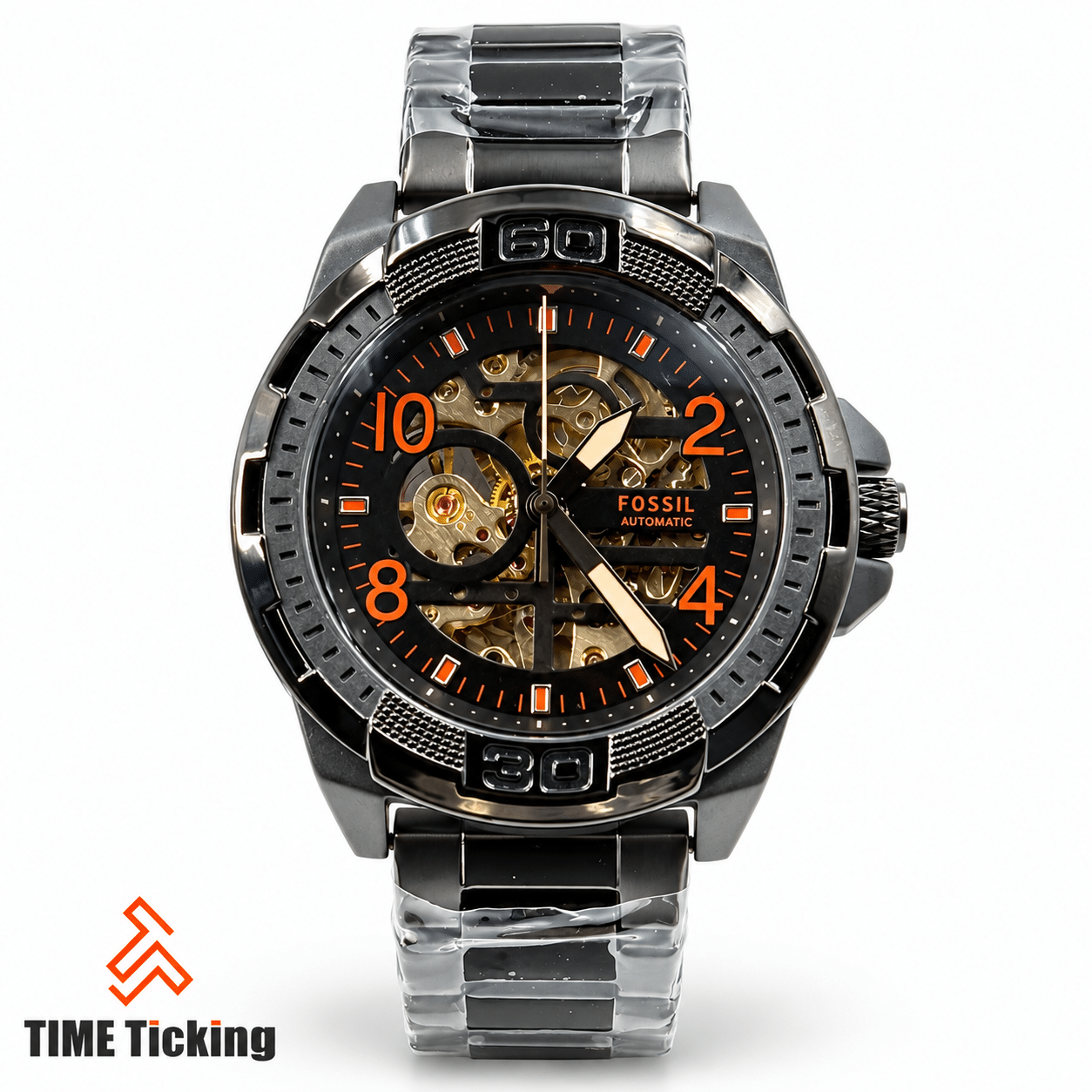 Fossil men's automatic skeleton watch with black dial, orange accents and stainless steel bracelet